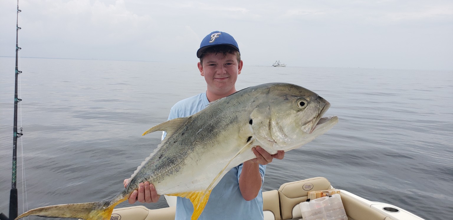 Young Gulf Coast angler holding a fish