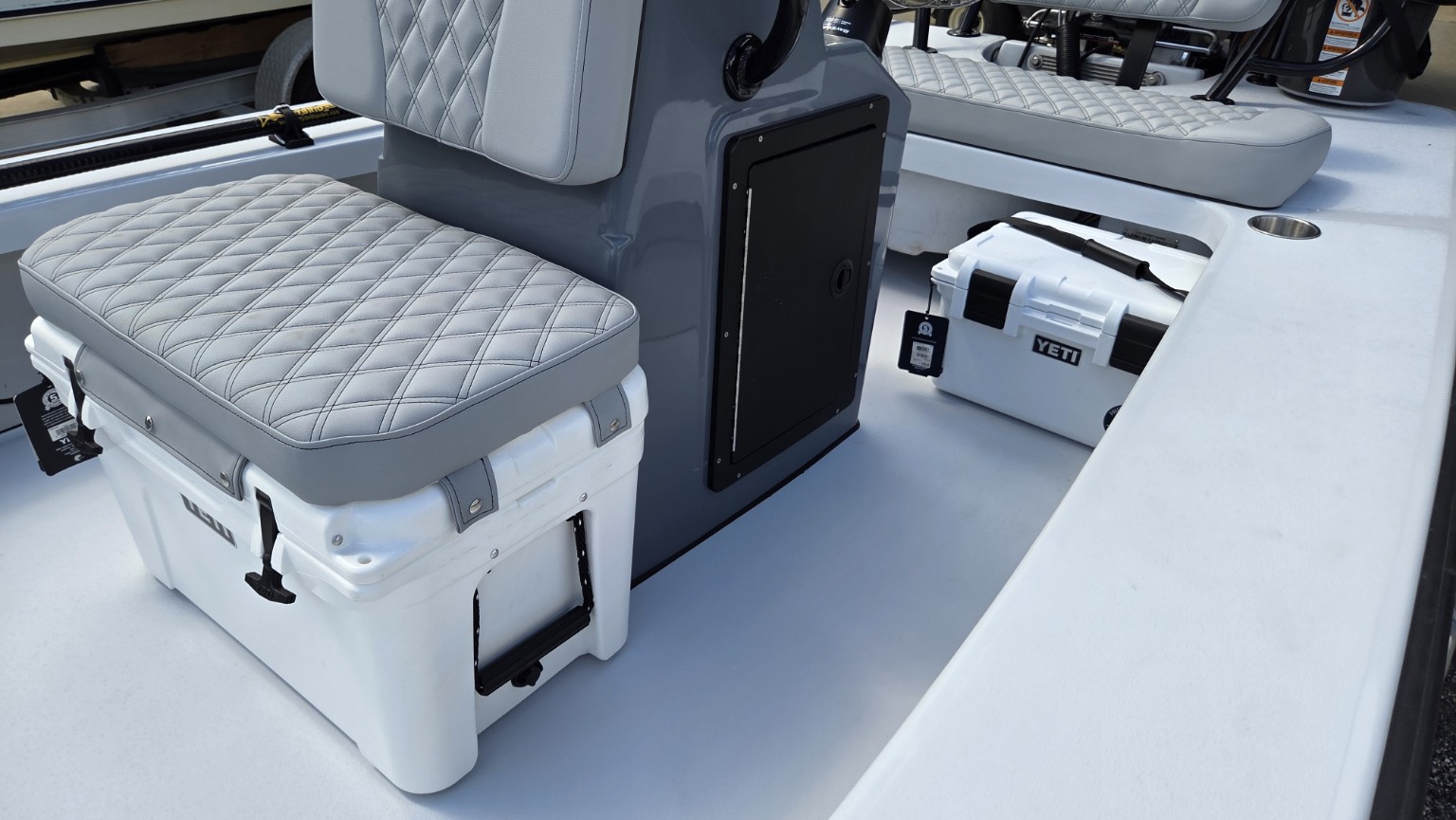 Quilted seating and onboard storage aboard the Delta D18.